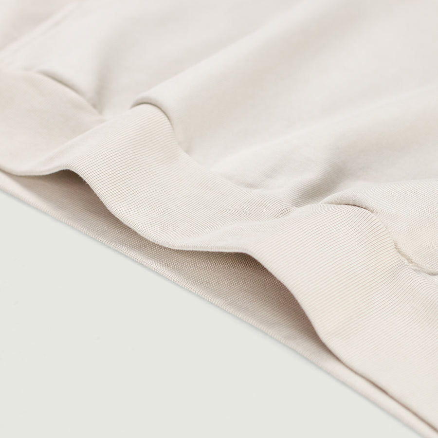 Detalle del dobladillo y tejido de algodón en sudadera Think Different beige EPIC ME