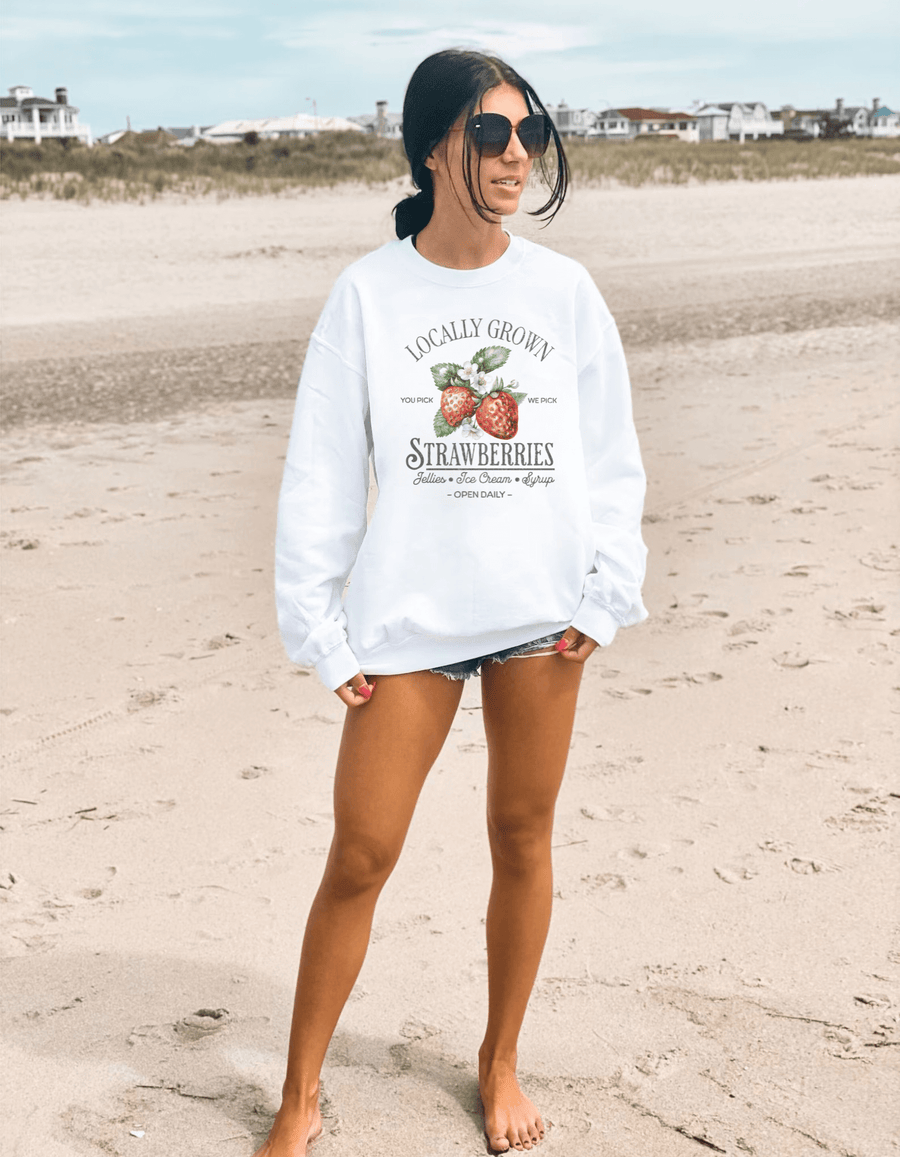 Mujer en la playa con sudadera sin capucha blanca Epic Me Strawberries y estampado de fresas vintage